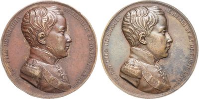 a close up of two medals with a child on them