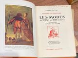 an open book with a picture of a man and a dog on it