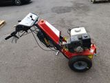 a small red machine that is sitting on the ground