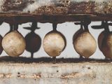 a close up of a metal object with balls on it