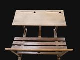 a wooden chair that is sitting on a black background