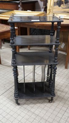 a black shelf that is on the floor in a room