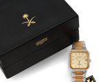 an image of a black box with a gold watch and a black box with a gold watch on it