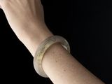 a woman ' s hand holding a cell phone up to her ear