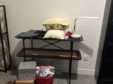 a room with a red rug and a table with a pillow on it