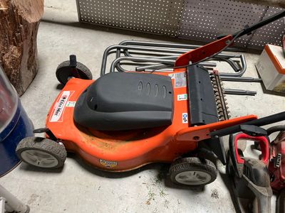 a lawn mower that is sitting on the ground