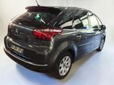 the back of a black citrole parked in a white room