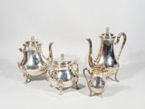 a silver plated tea set with four pieces of silverware