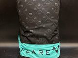 the back of a black backpack with a green ribbon around it