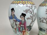 pair of asian vases with a woman and a tree in the background