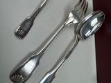 three spoons and two spoon spoons on a table