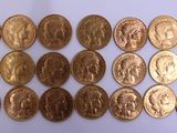 a close up of a bunch of gold coins on a white surface
