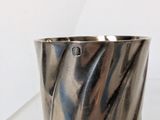 a silver cup that is sitting on a table