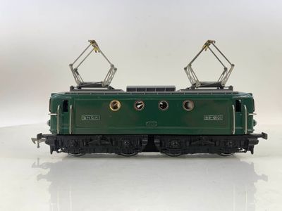 a green train on a white surface with a white background