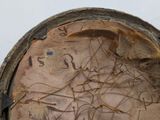a close up of an old hat with writing on it