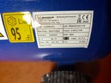 a close up of a blue machine with a yellow tag on it