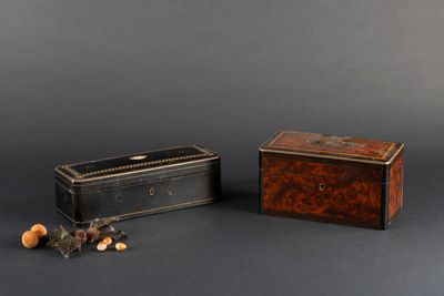 two small wooden boxes sitting next to each other on a black surface