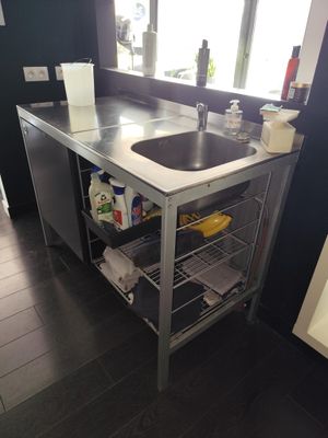 a kitchen with a sink and a dishwasher in it