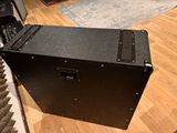 a black box sitting on a hard wood floor