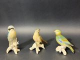 three figurines of birds sitting on top of each other