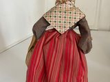 a figurine of a woman in a red dress