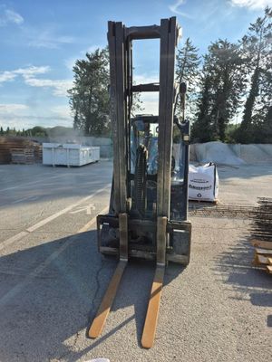 a forklift that is parked on the side of the road