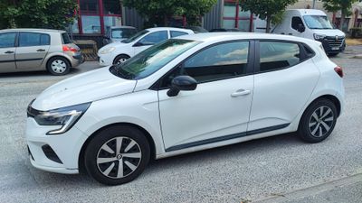 a small white car parked on the side of the road