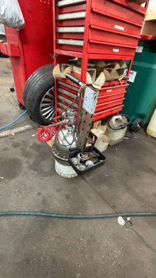 an image of a garage with a red toolbox and a red cart