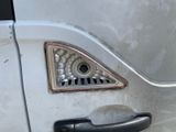 a close up of a door handle on a white car