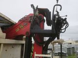 a red machine that is sitting in the back of a truck
