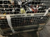 a metal cage filled with bottles of wine on the street