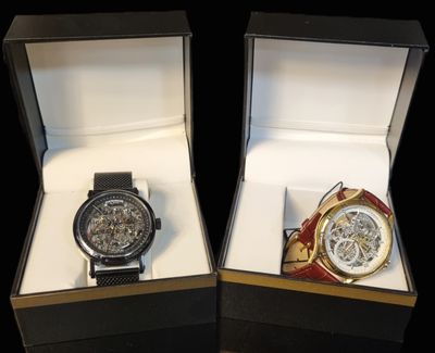 two watches that are in a box on a table