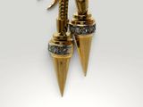 a close up of a pair of earrings with spikes on them