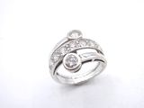 a close up of a diamond ring on a white surface