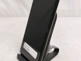 a cell phone that is on a stand on the table