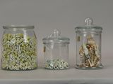 three glass jars filled with different types of food