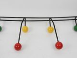 a close up of a metal object with colorful balls on it