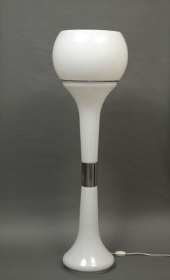 an image of a white table lamp on a gray surface