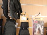 several pairs of gloves hanging on a wall in a store