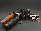 un tas de vieux appareils photo posés sur une table
