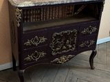 a purple cabinet with a marble top and a book shelf