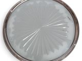 a silver plate with a circular design on it
