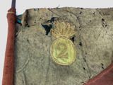 a gold medal on a piece of cloth with a red tie