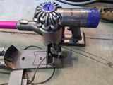 a vacuum that is sitting on the floor next to some wires