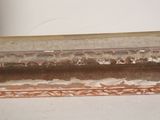 a close up of a window sill with peeling paint on it