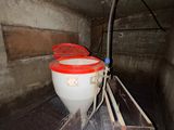 two buckets that are sitting on a shelf in a room