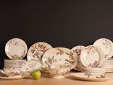 a lot of plates and bowls on the table
