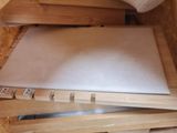 a wooden box with a knife and a piece of paper on it