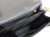 a black purse that is open on a white surface