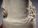 a close up of a statue of a woman with flowers on it